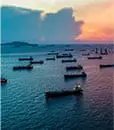 Oil ships on the water at dusk representing Lacima's work in the LNG markets, offering a complete solution for structuring and trading, to risk management of LNG portfolios.